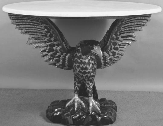 Eagles are a powerful symbol in American designs from the Great Seal to everyday decorative arts. A carved eagle holds up this table’s faux marble top.